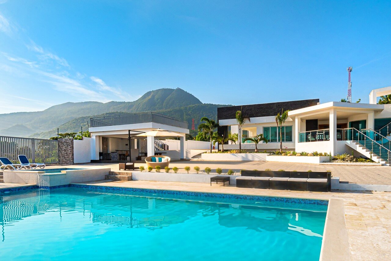 Melody Village pool with mountain and ocean views at golden hour
